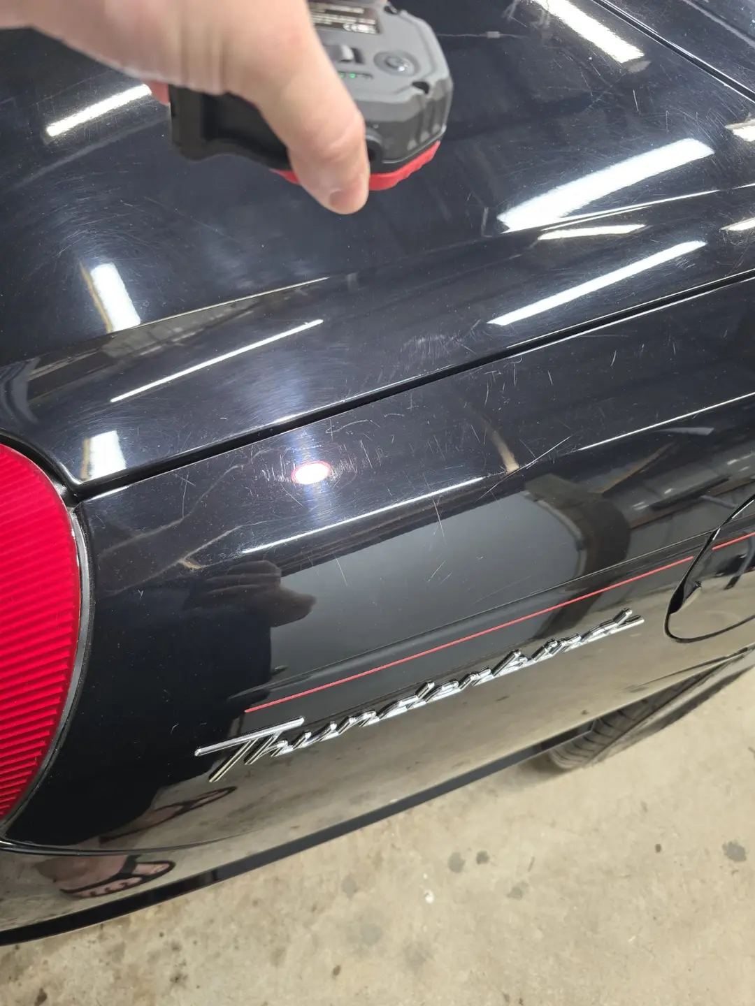 Scratches and wash marring on the Thunderbird rear quarter before correction