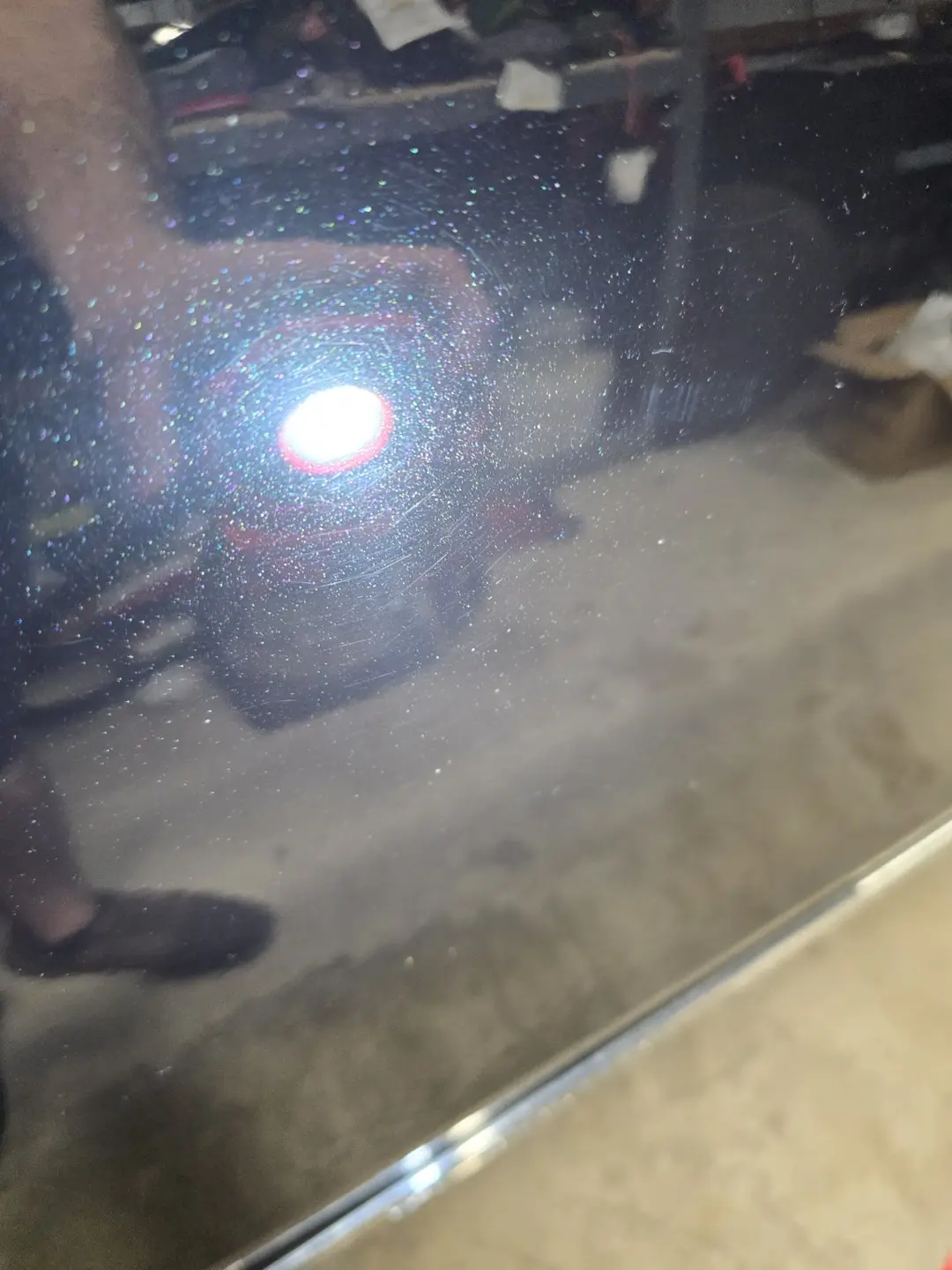 Wash marring visible under inspection light on an XC90 door before correction